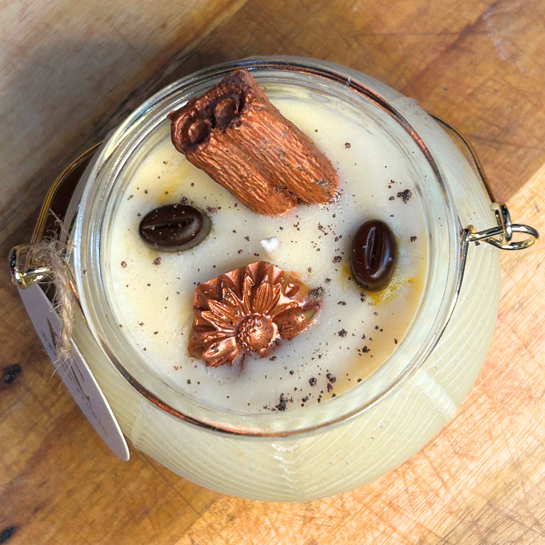 Top view of Autumn Roast Candle – creamy marshmallow layer topped with cinnamon stick, brown flower, two coffee beans, and brown mica powder shimmer.