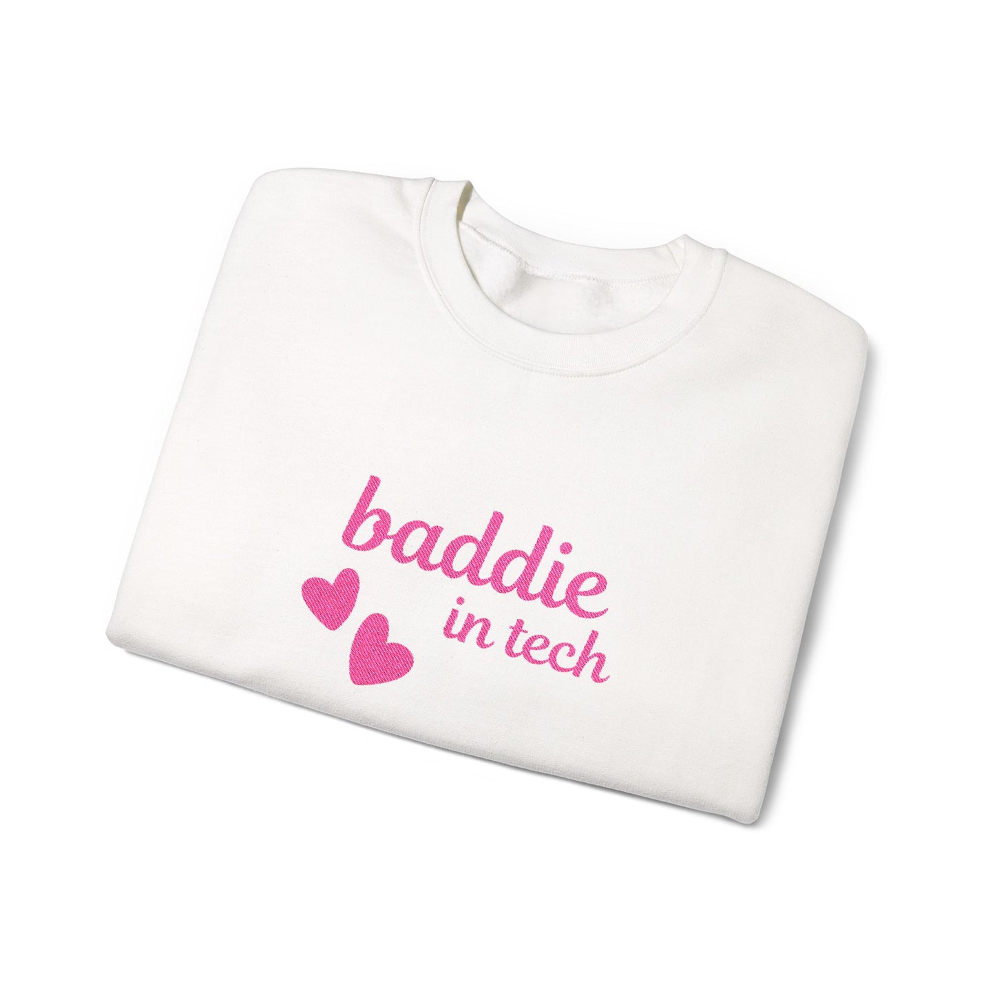 Baddie in Tech sweatshirt folded with bold pink text and two floating hearts visible – unisex crewneck, cozy cotton-poly blend, perfect gift for tech-savvy fashionistas.