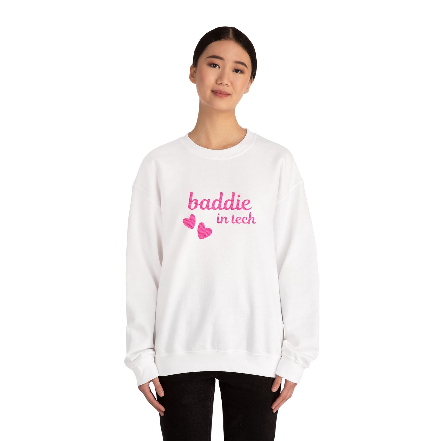 Woman wearing Baddie in Tech sweatshirt – bold pink text with two floating hearts, unisex crewneck, stylish and cozy for casual, creative, or tech-inspired outfits.