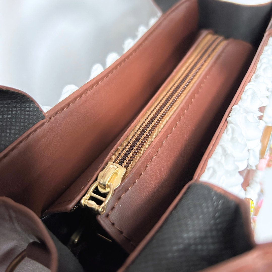 Close-up of the Chocolate Bar Purse closed zipper with detailed stitching.