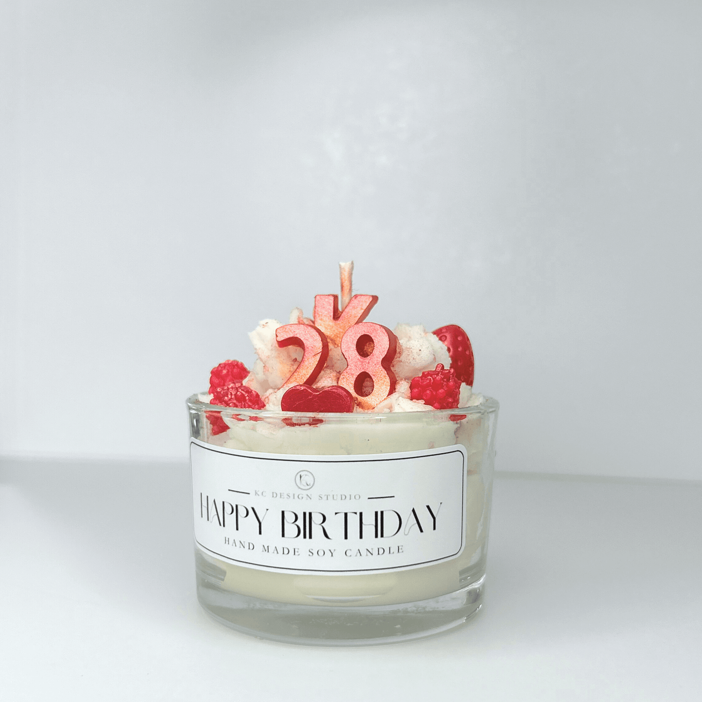 Side view of Custom 4oz Birthday Candle, highlighting its personalized design, toppings, and base color.
