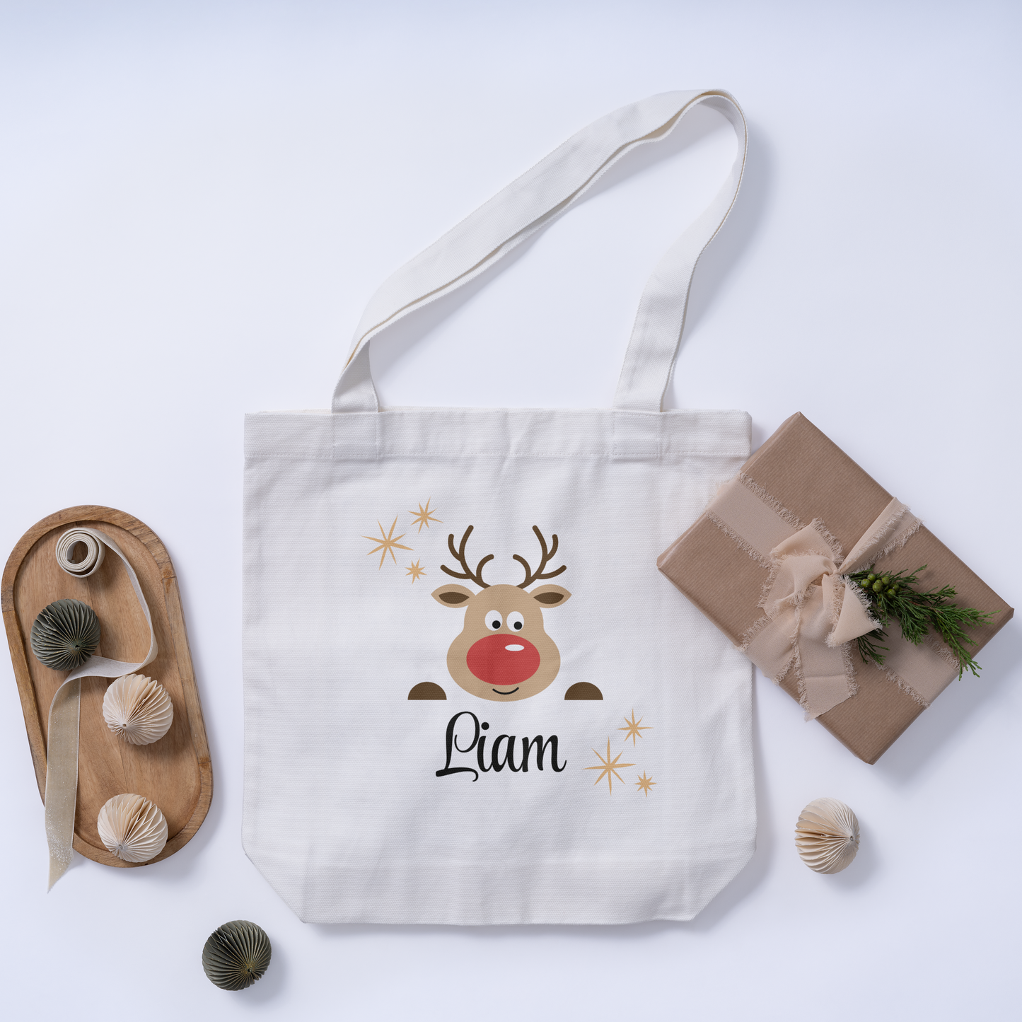 Custom Christmas white tote bag featuring a reindeer design on the initial, along with a customizable name for a fun and festive holiday accessory.