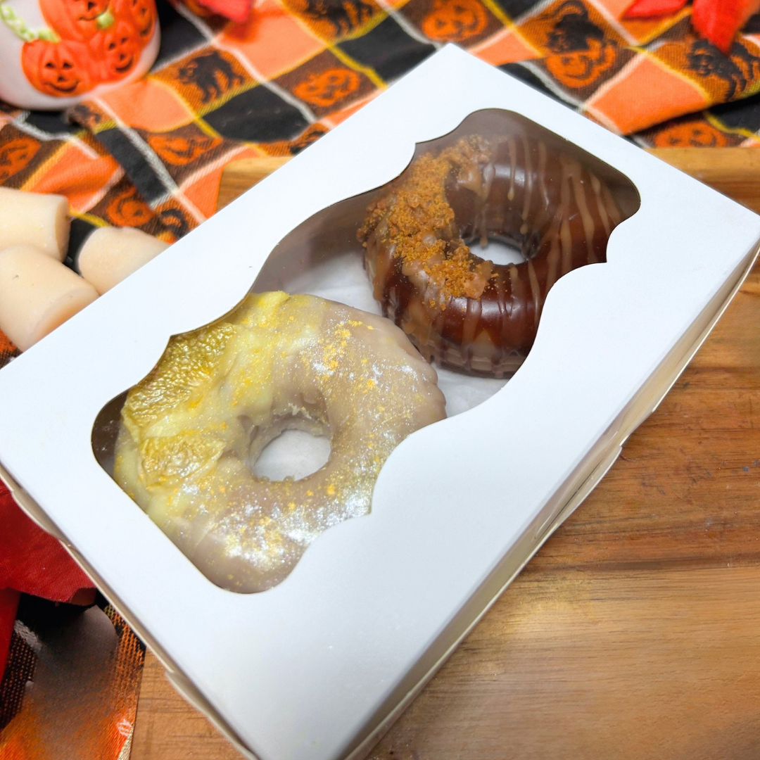 Closed small bakery box containing the Lemon Drop and Honey Crunch donut wax melts.