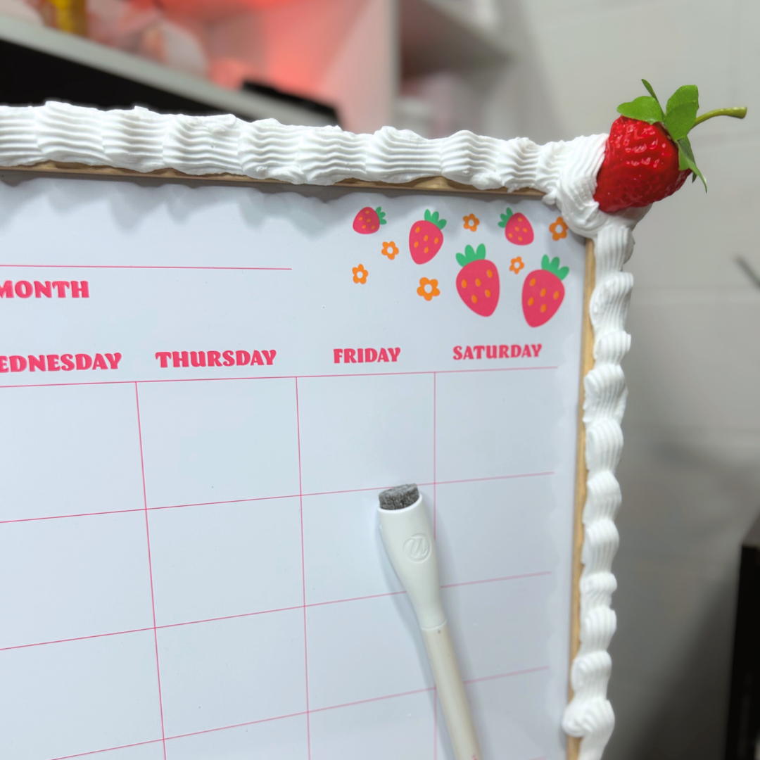 Calendar with decorative border featuring strawberries and frosting.
