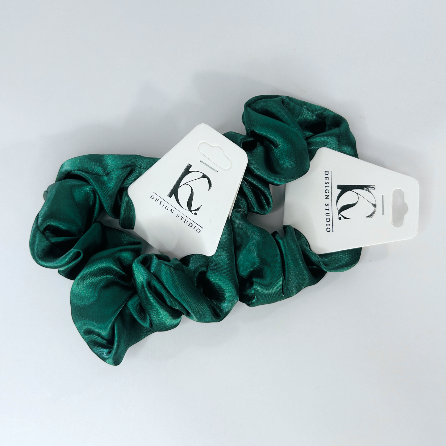 Vibrant green silk scrunchie offering a lively accent to your style.