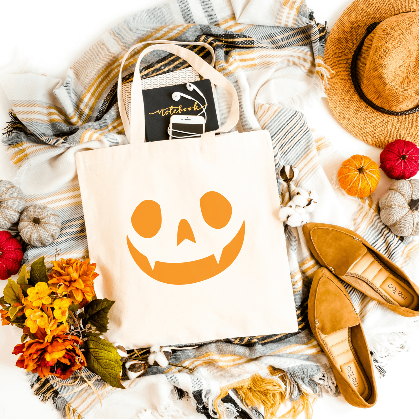 White Halloween Face Tote, designed for durability and spacious enough for festive outings.