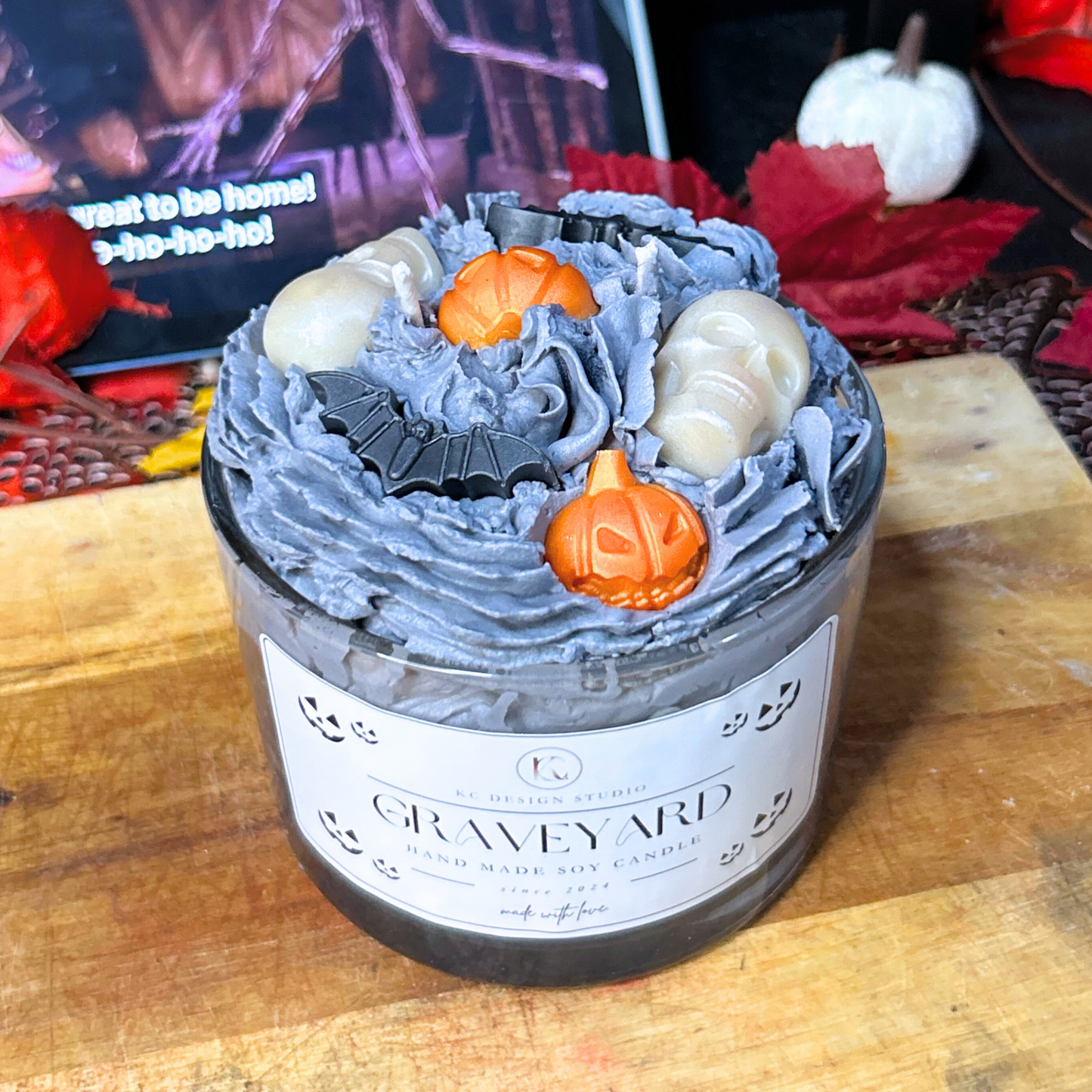 Angled view of Nightmare Before Christmas-inspired Halloween Graveyard Candle with layered witches brew, vanilla crumb, and whipped cream scents.