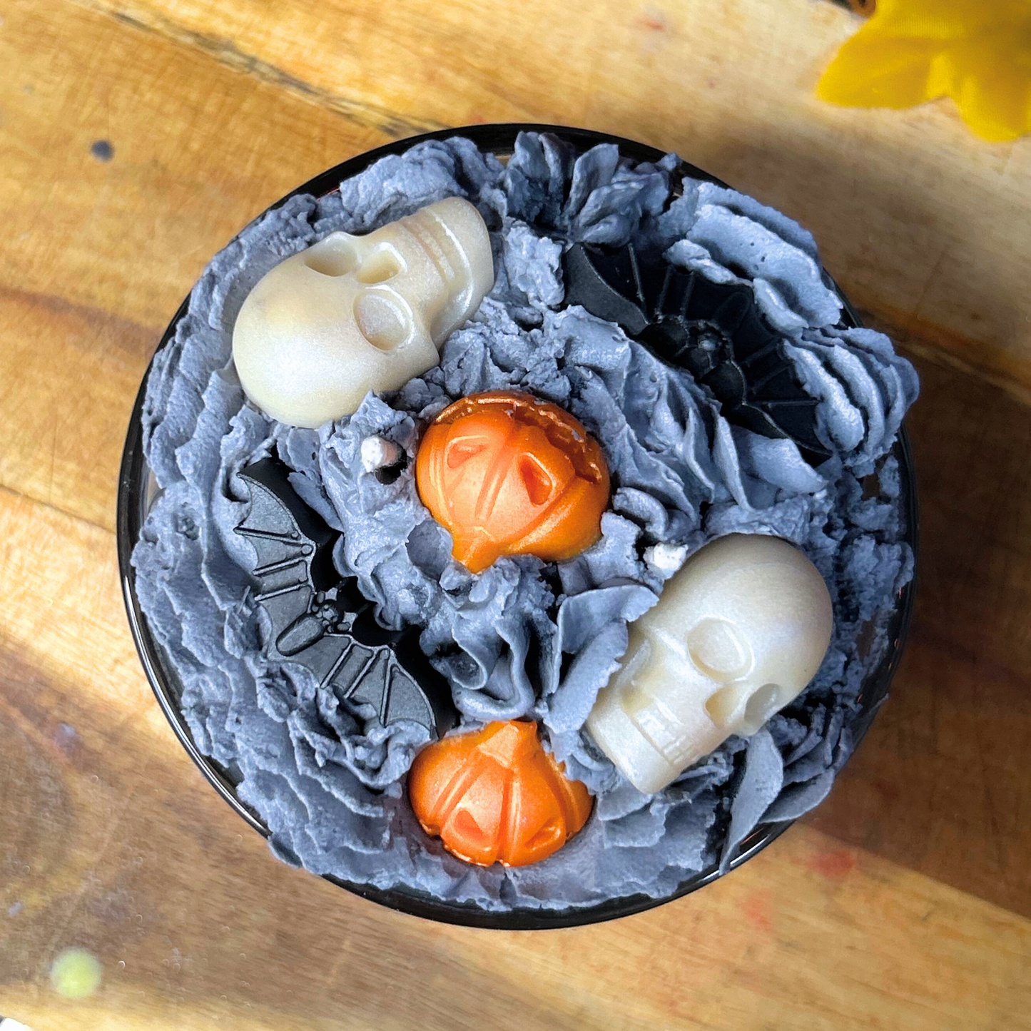 Top view of Halloween Graveyard Candle with spiral hill-inspired design, pumpkins, skulls, and bats for a spooky Nightmare Before Christmas vibe.
