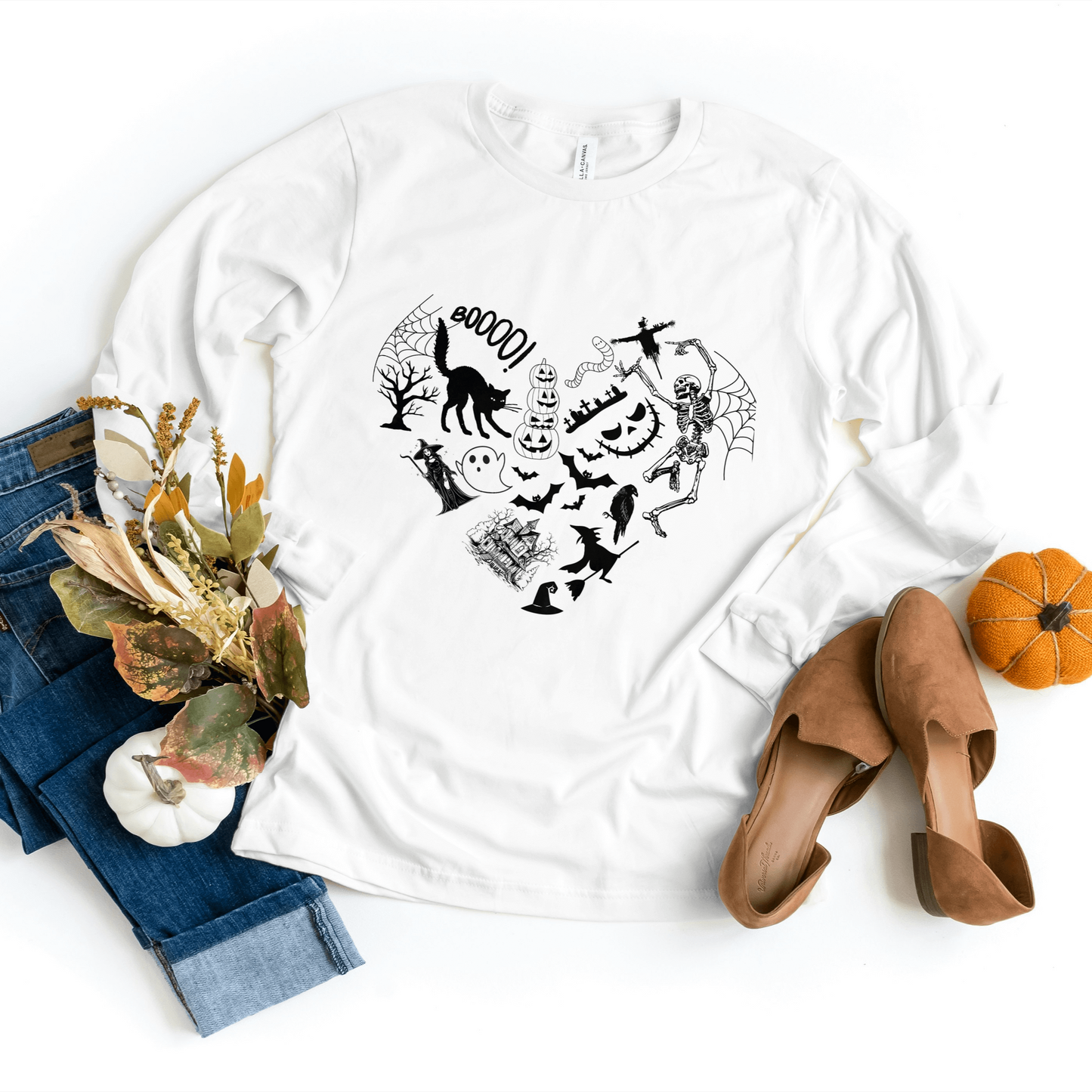 White Halloween heart sweater featuring spooky silhouette shapes.