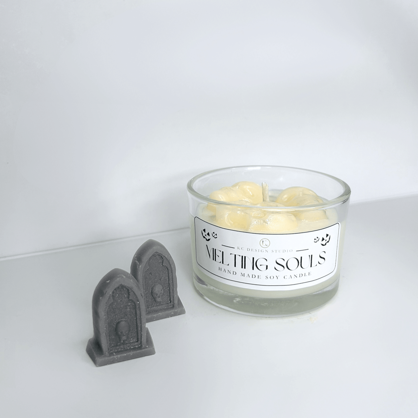 Alternate front view of the Melting Souls Candle, featuring detailed melting skulls and eerie Halloween atmosphere.