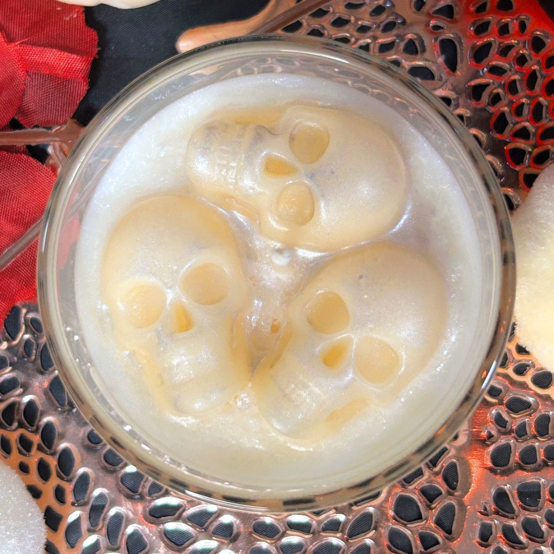 Top view of the Melting Souls Halloween candle featuring three melting skulls, inspired by gothic décor and the Corpse Bride aesthetic.