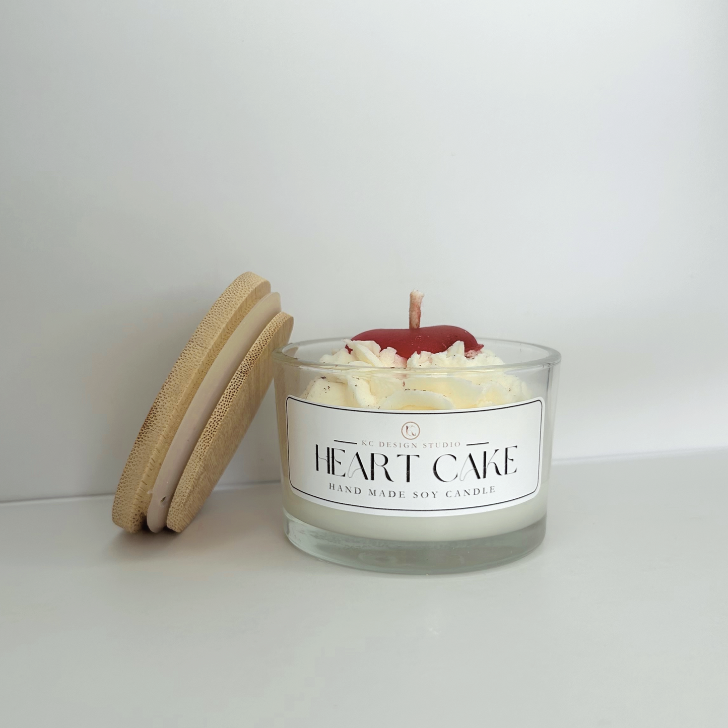 Front view of the Heart Cake Candle showcasing its decorative design and creamy vanilla buttercream scent.