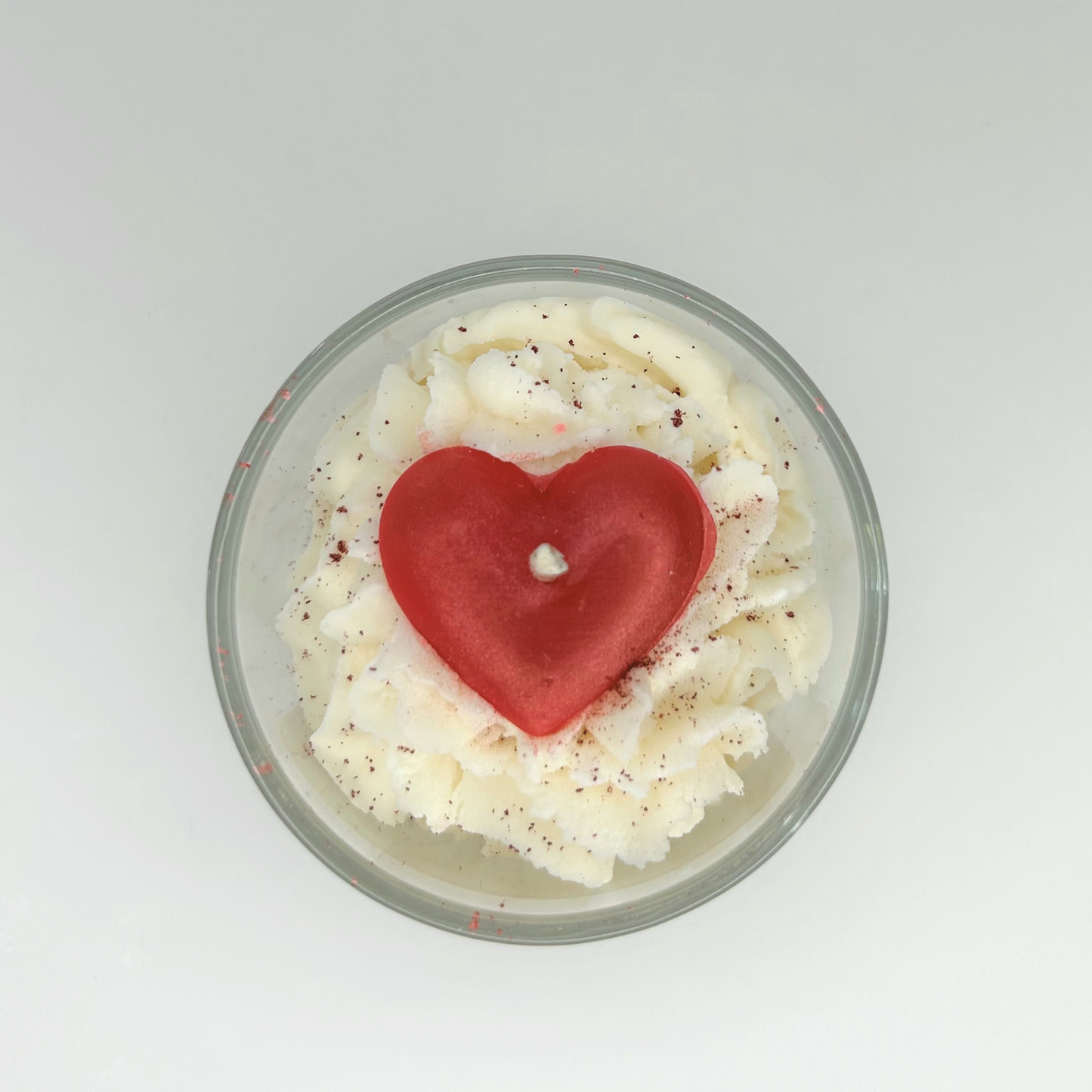 Top view of the Heart Cake Candle, highlighting the intricate heart decoration and layers of creamy wax.