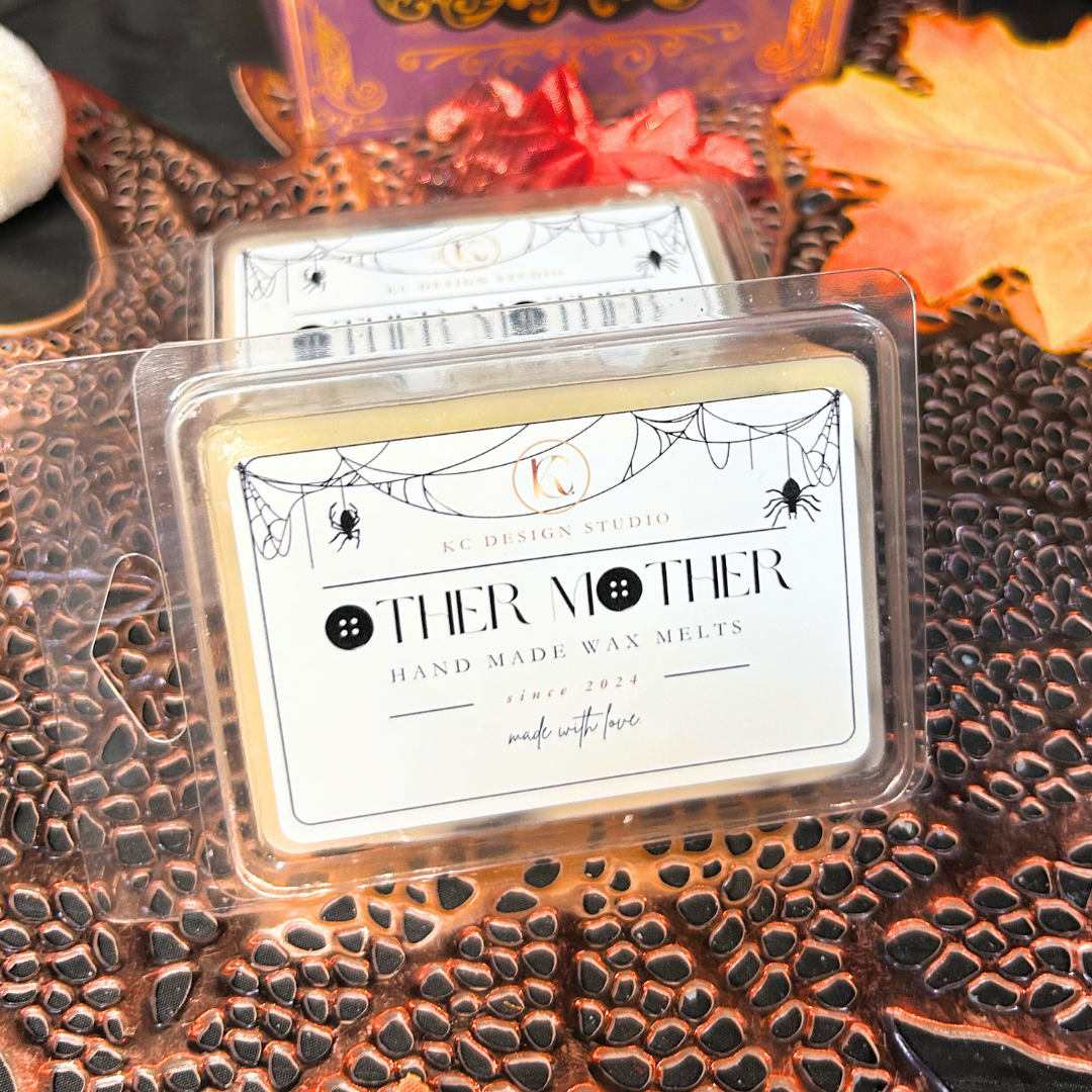 Handmade wax melt packaging with 'Other Mother' label on a textured surface.