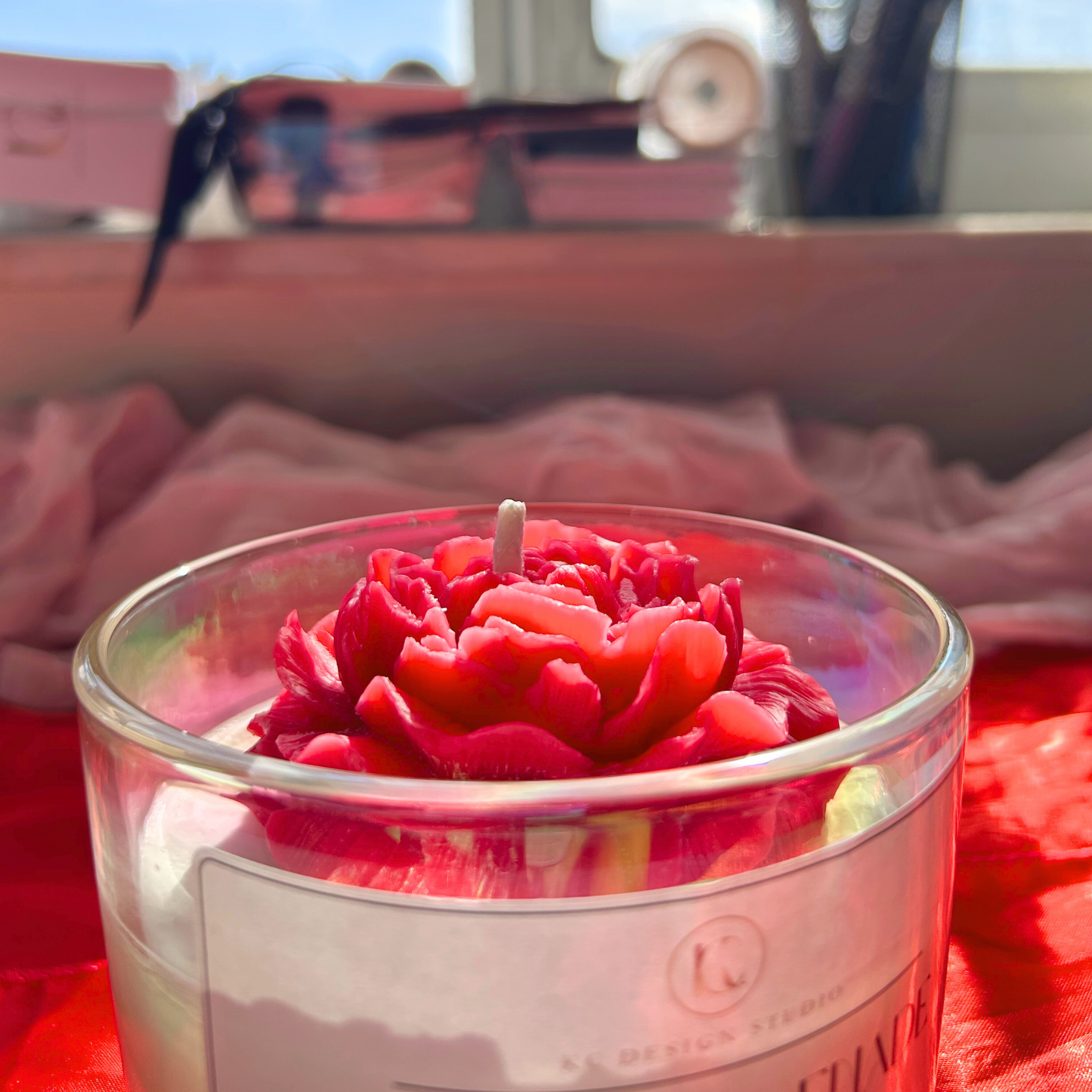 Close-up of Peony Serenade candle, highlighting the intricate details of the big peony topper and the smooth wax finish with a floral peony and peach magnolia aroma.