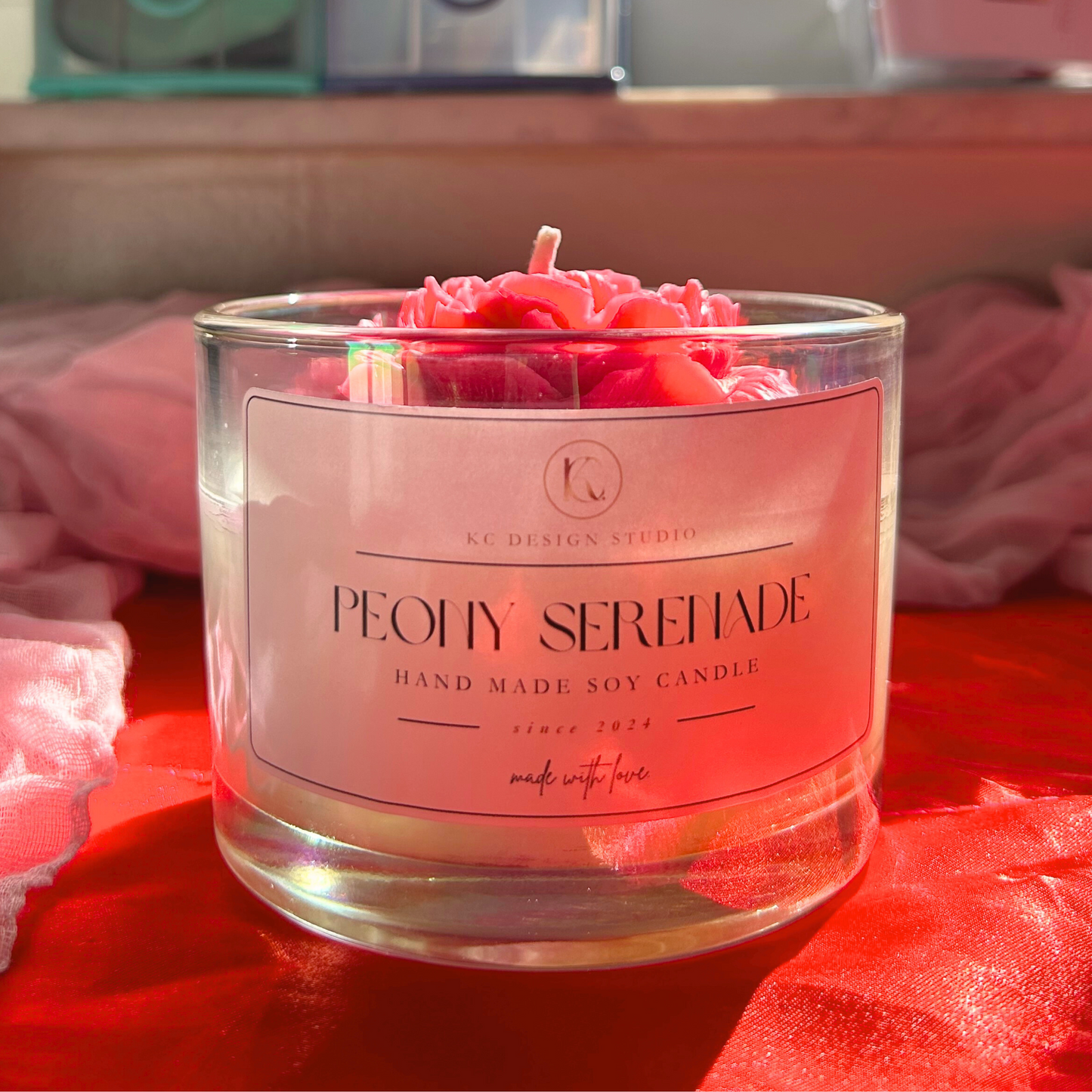 Front view of Peony Serenade candle, delicately scented with peony and peach magnolia, topped with a beautifully crafted big peony for an elegant touch.