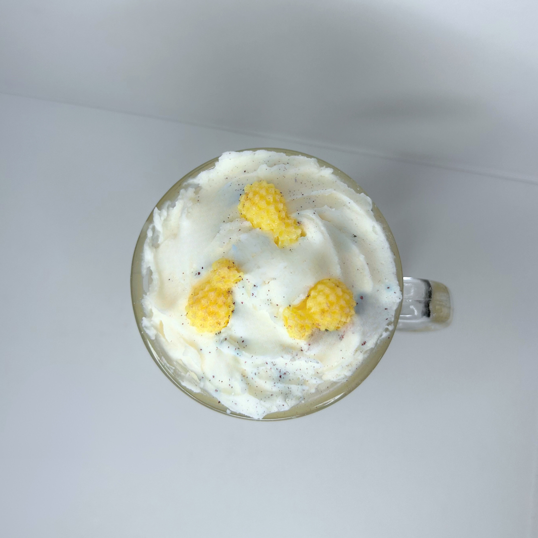 Top view of Piña Colada candle showing whipped white layer and three mini pineapple wax toppings