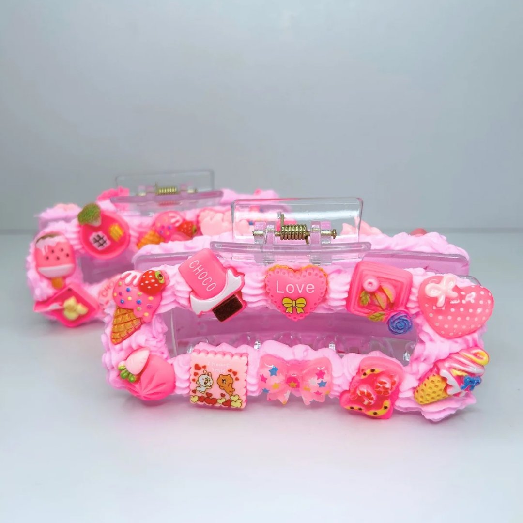 Pink creamy hair claws with geometric elements and cute charms - front view.