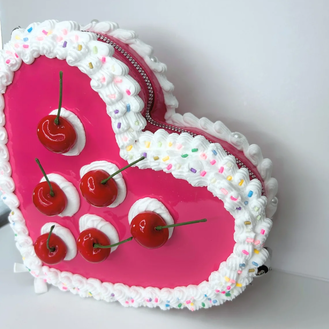 Top view of pink cherry cake purse showing spacious interior and adjustable strap