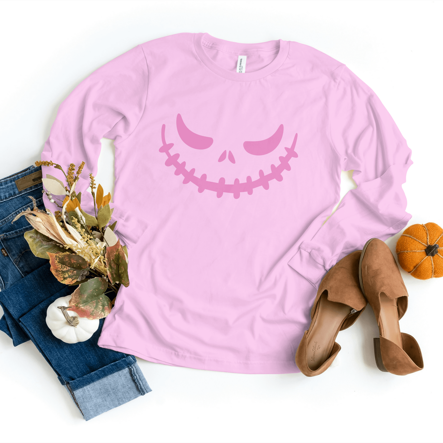Vibrant pink Pumpkin Face Sweatshirt featuring a cozy design, perfect for adding a fun touch to your Halloween wardrobe.