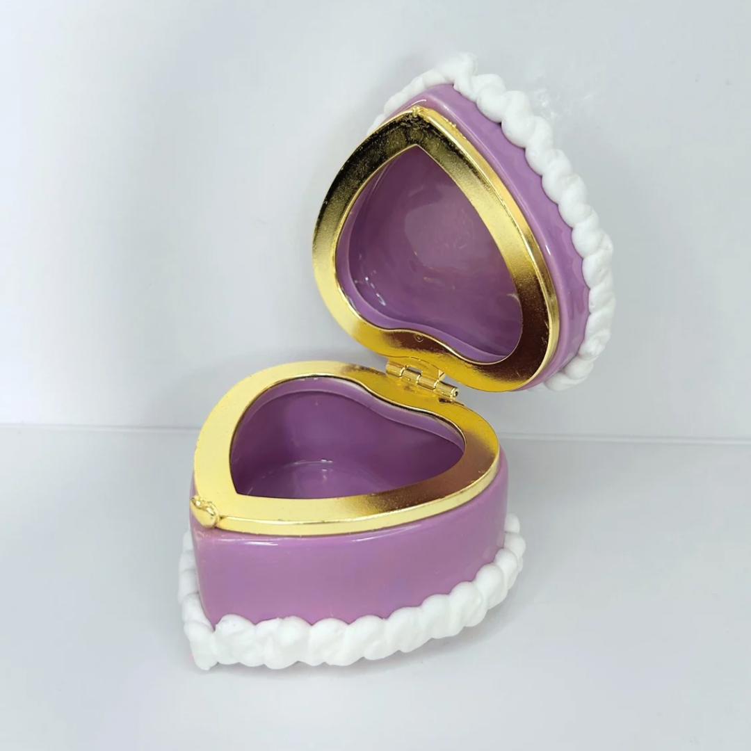 Open view of a purple kawaii mini heart-shaped jewelry box with decorative cream and cute charms, revealing storage space inside.