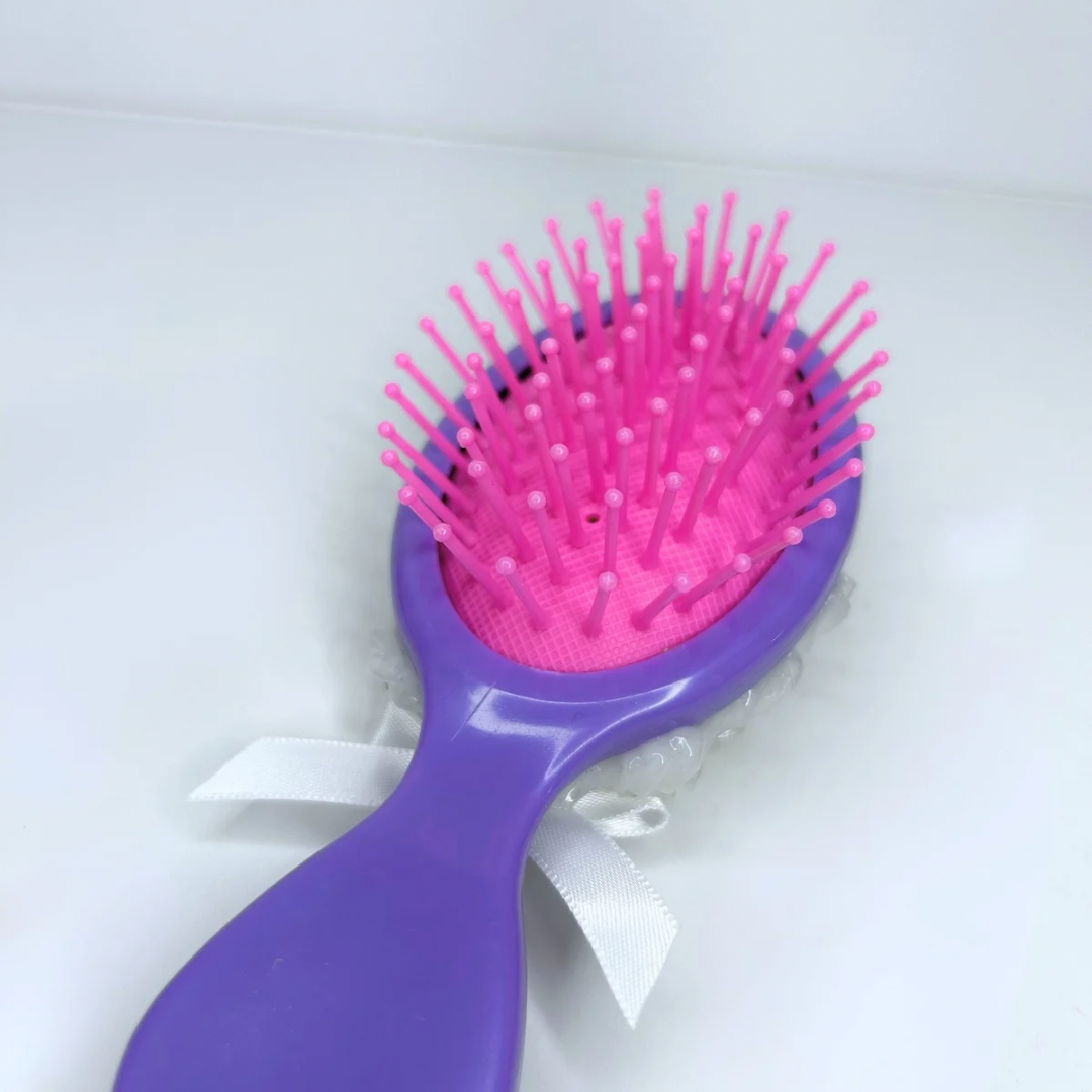 Macro shot of the soft silicone bristles on the purple hair brush, designed to detangle without damage
