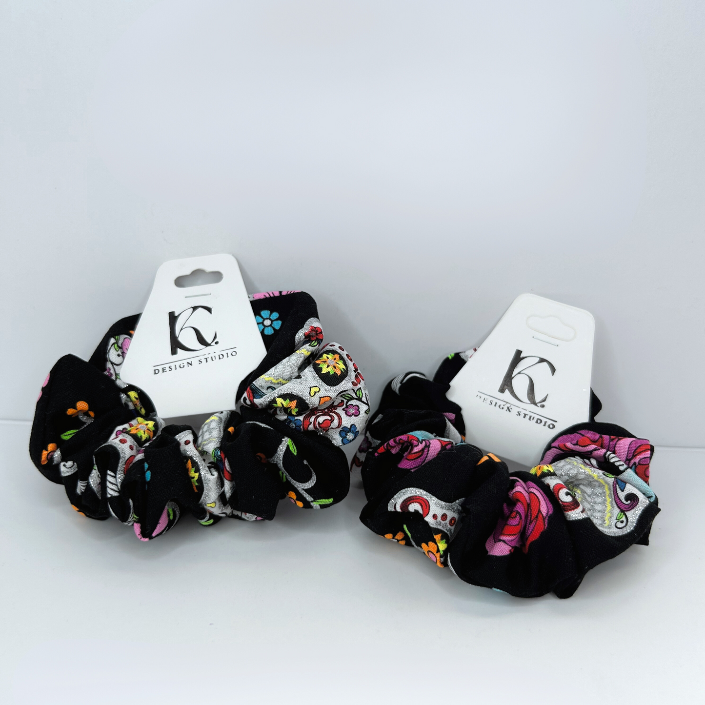 Front view of scrunchie featuring a colorful skull pattern, made with a 7-inch elastic for a secure and comfortable fit.