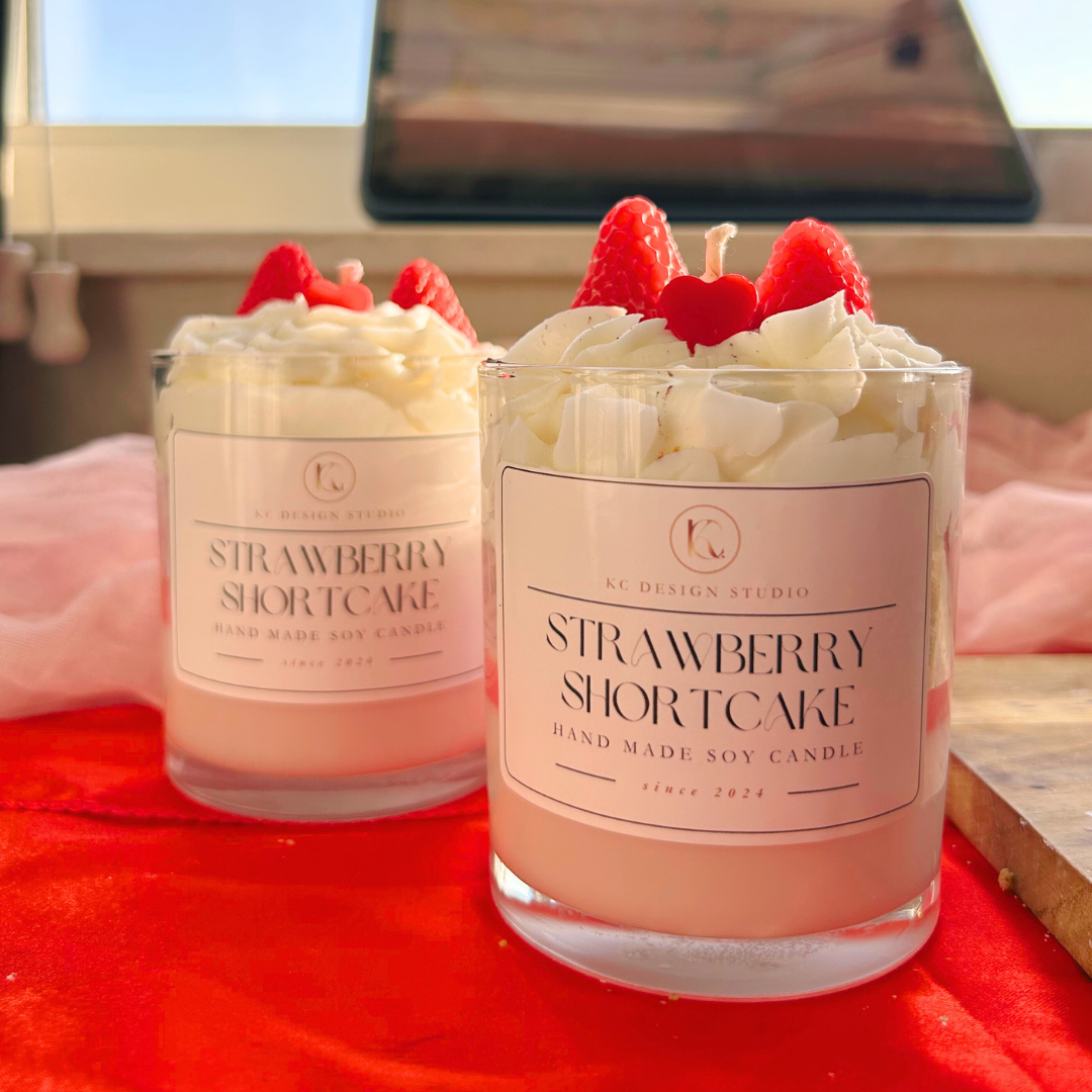 Front view of a strawberry shortcake candle showcasing layered cake design and strawberry garnish.