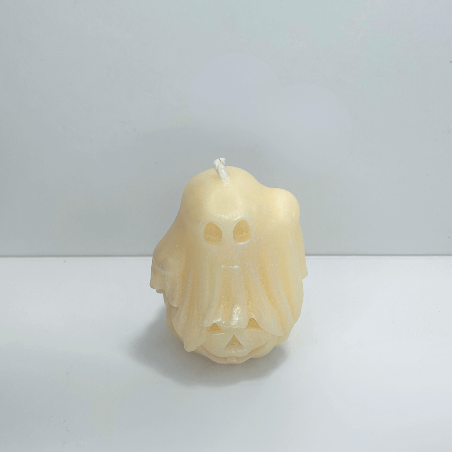 Top view of decorative ghost candle with cotton candy scent, showcasing the ghost and pumpkin design.