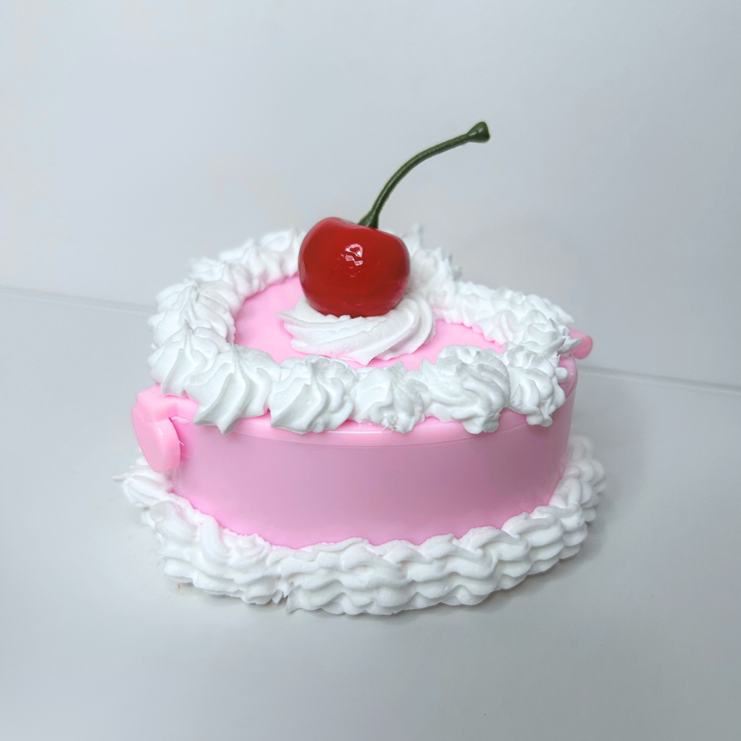 Side view of the Whimsical Vintage Heart-Shaped Jewelry Box highlighting the intricate cake-inspired design and vibrant colors