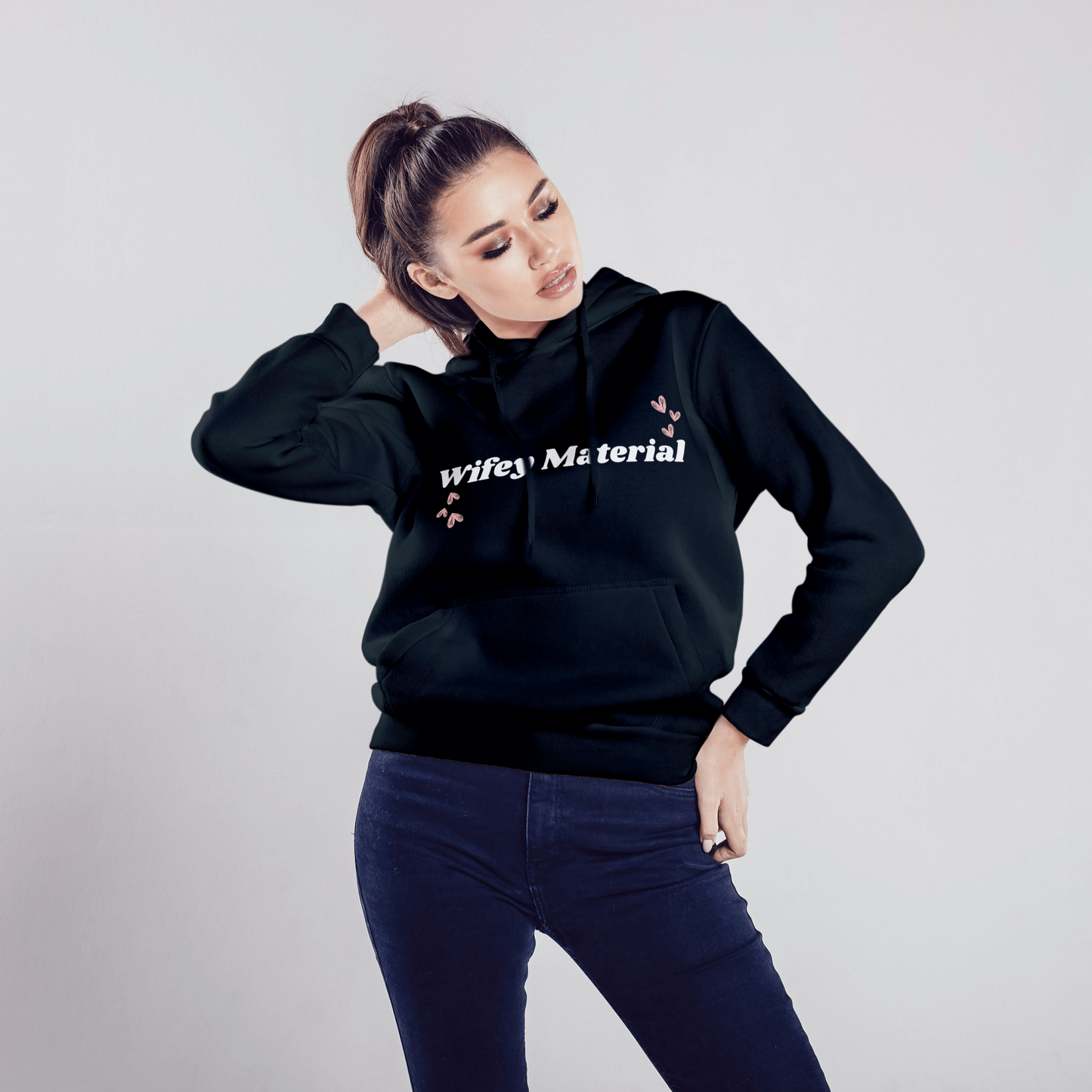 Black "Wifey Material" Hoodie with a cozy, relaxed fit, double-lined hood, and adjustable drawstrings for a customizable look.