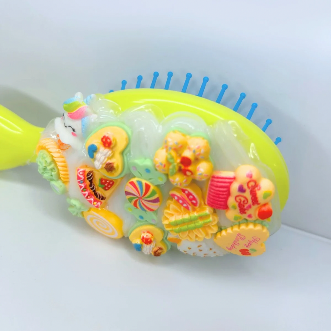 Zoomed-in detail of the charm designs on the yellow brush — playful, cute, and full of personality