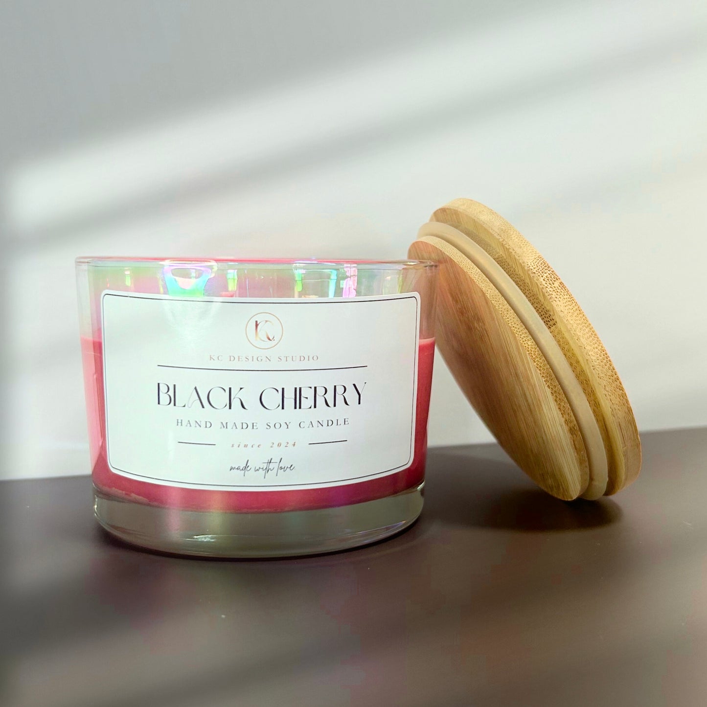 Front view of the 16oz Black Cherry candle, showcasing its burgundy color and sleek design, made with all-natural soy wax and an eco-friendly cotton wick.