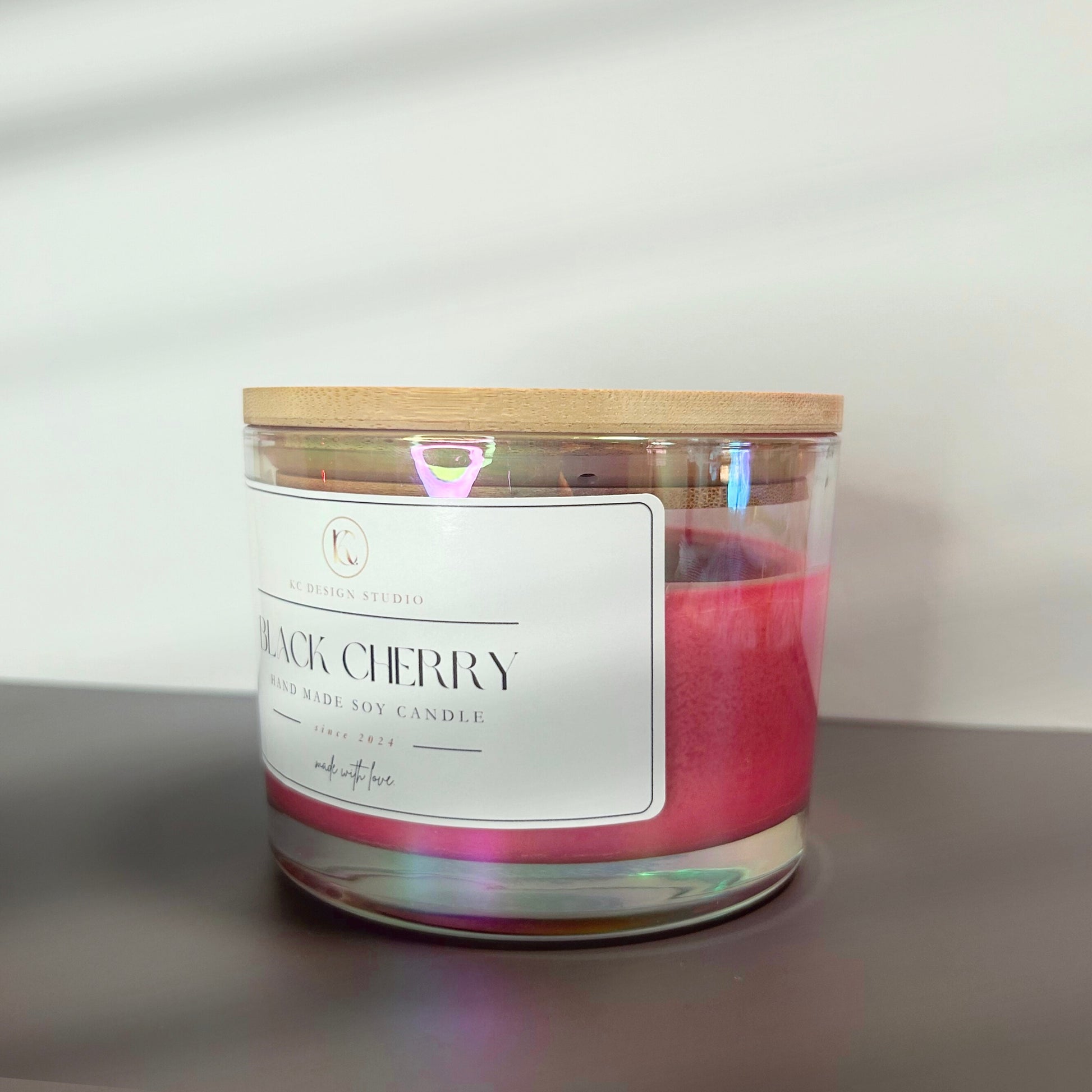 Side view of the 16oz Black Cherry candle, displaying its elegant, burgundy design and sturdy vessel made for a long-lasting burn.