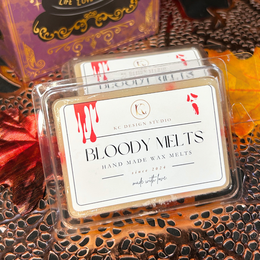 Bloody Melts hand-made wax melts packaging with 'KC Design Studio' branding on a decorative surface.