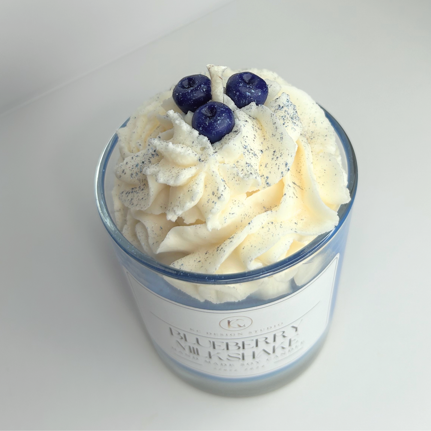 Close-up view of the Blueberry Milkshake candle, showcasing the rich texture and vibrant colors of the blueberry and vanilla layers.