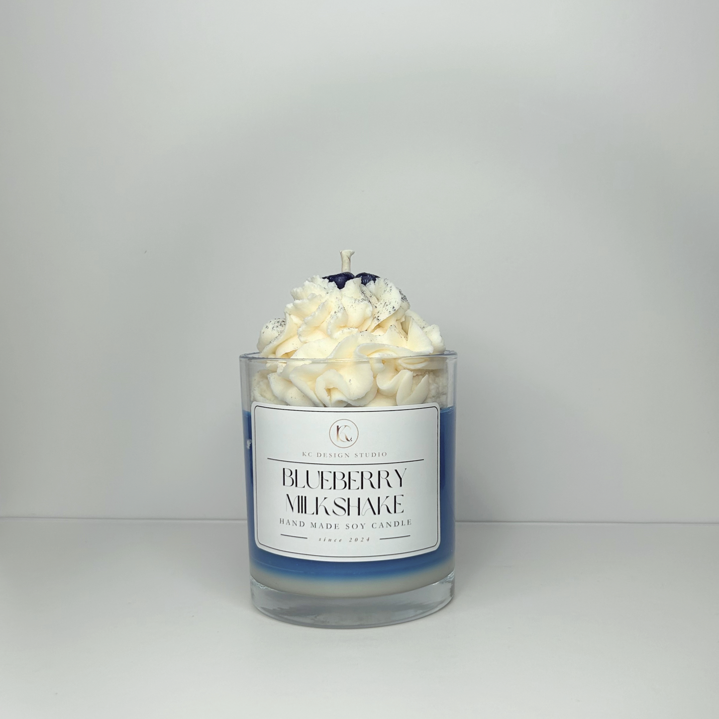 Front view of the Blueberry Milkshake candle, showcasing its creamy vanilla and blueberry design.