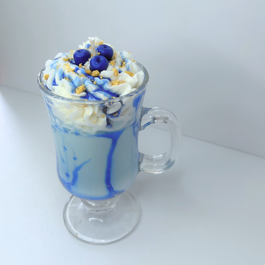 Front view of Blueberry Milkshake Candle with whipped cream topping, blueberry syrup, and realistic dessert details in a glass Irish mug.
