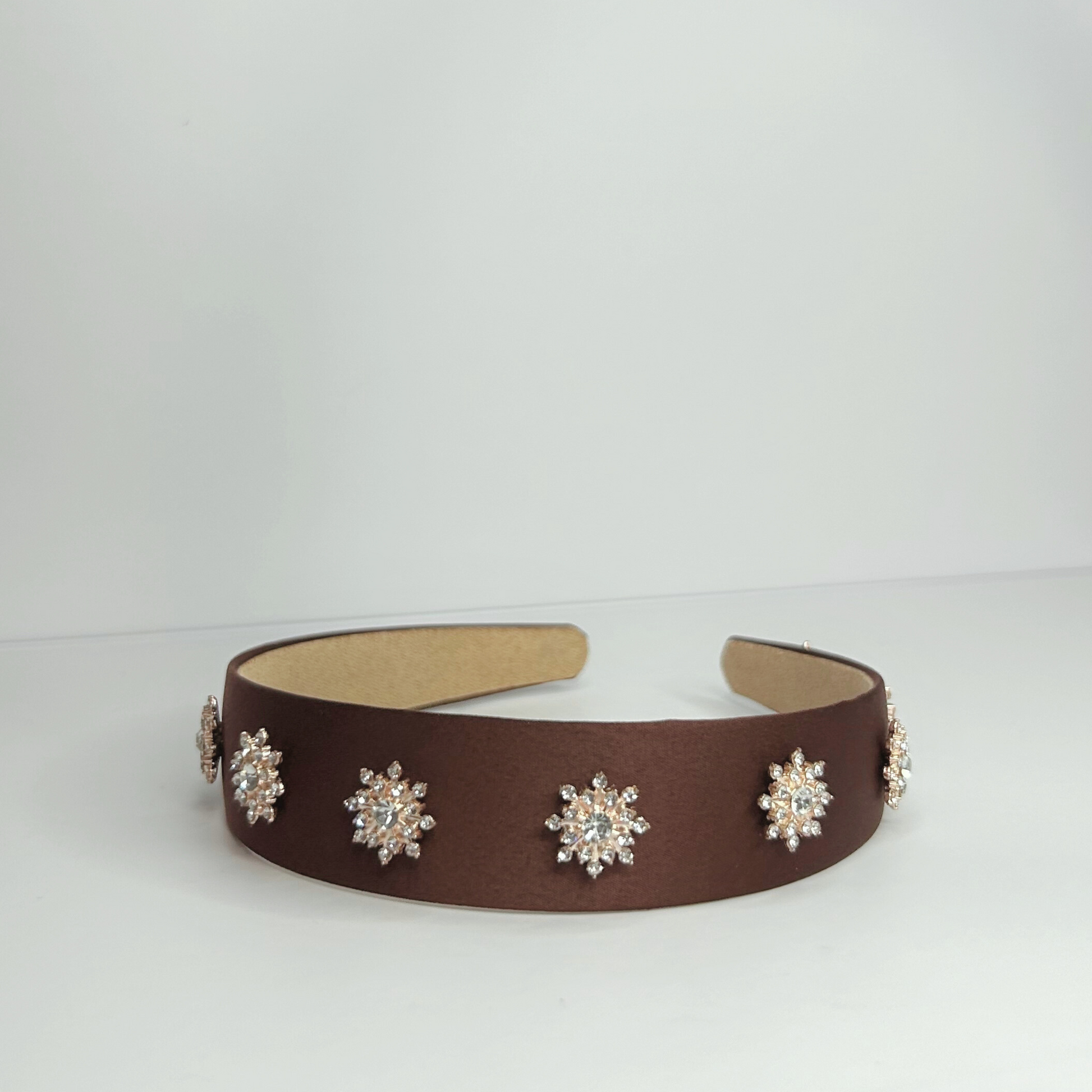 Brown alloy headband, sleek polyester accessory for a chic and elegant everyday look.