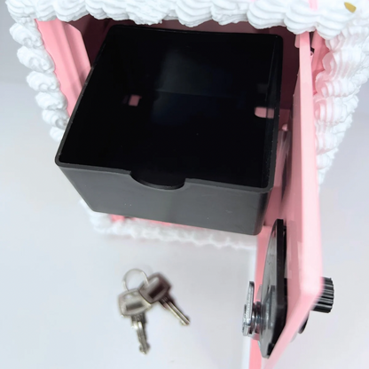 Close-up of Cake Vault mini locker interior with coin basket and bottom storage.