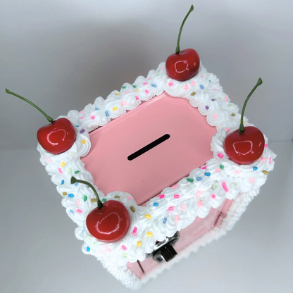 Top view of pink cake-inspired mini locker with frosting and cherry design.