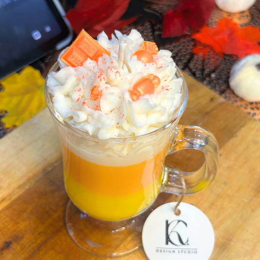 Angled view of Candy Corn Candle showcasing three layers and playful Halloween-themed toppings.