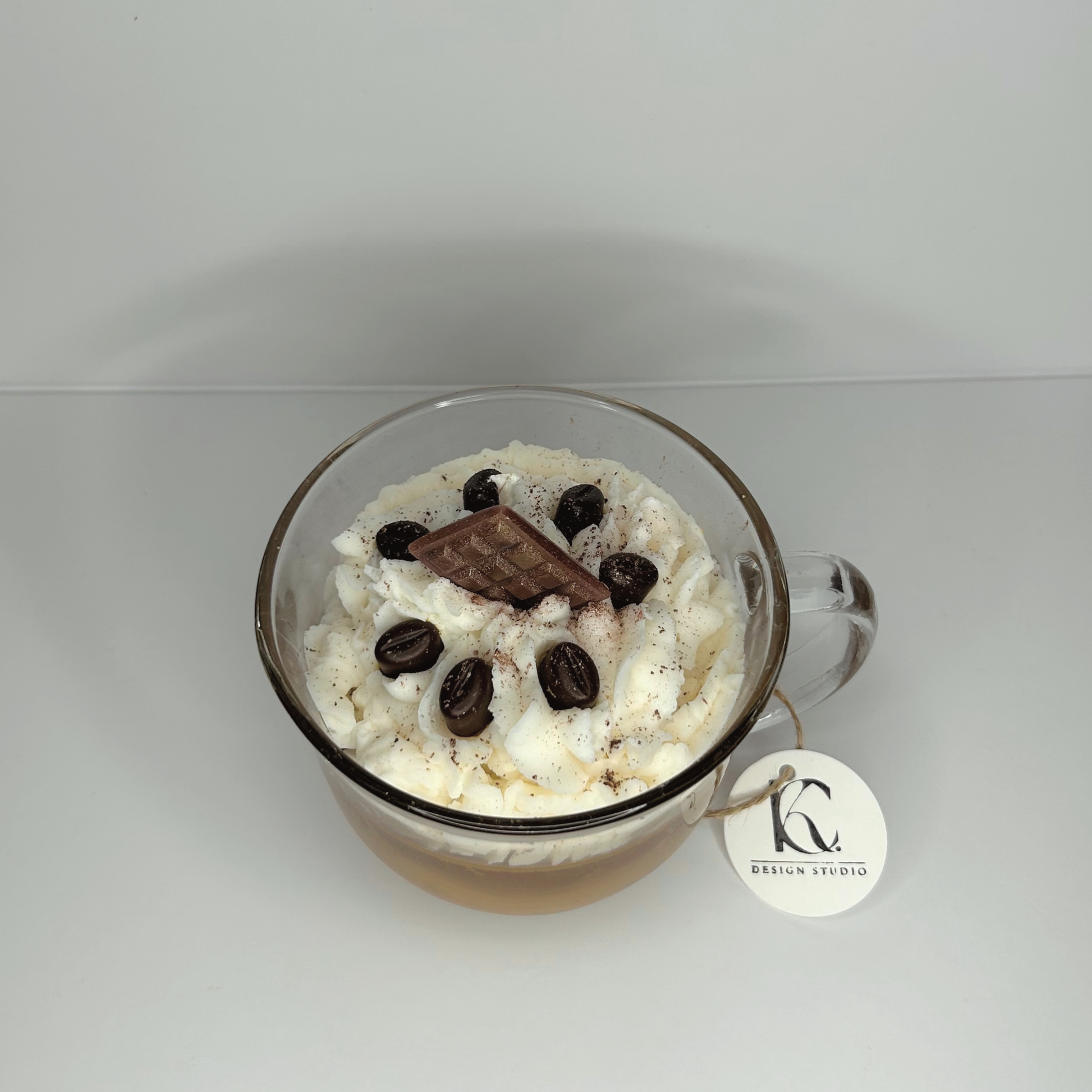 Top view of Chocolate Vanilla Latte Candle featuring a decorative layer of whipped cream, mini coffee beans, and a chocolate bar, with visible scents of coffee house, vanilla buttercream, and salted caramel.