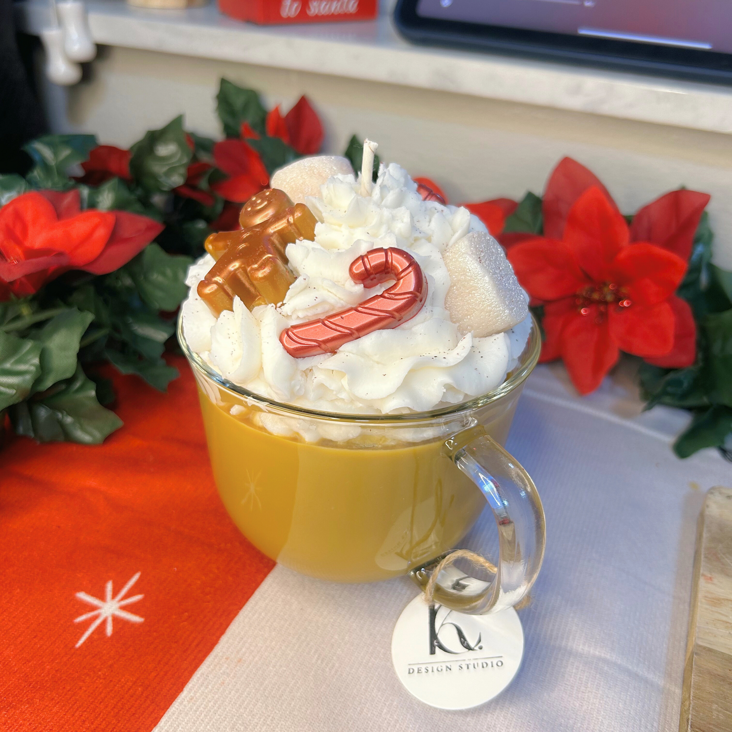 Side view of Christmas Hot Chocolate candle showing festive layers and toppings in a glass mug.