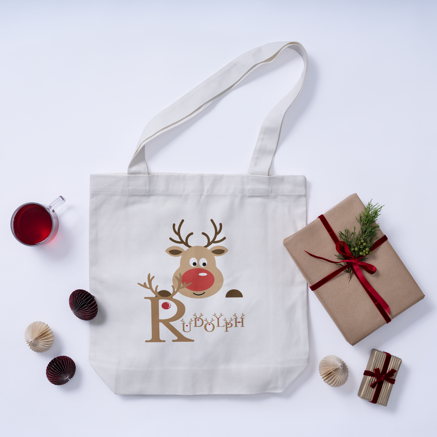 Christmas white tote bag featuring a Rudolph design and festive holiday details, perfect for celebrating the season.