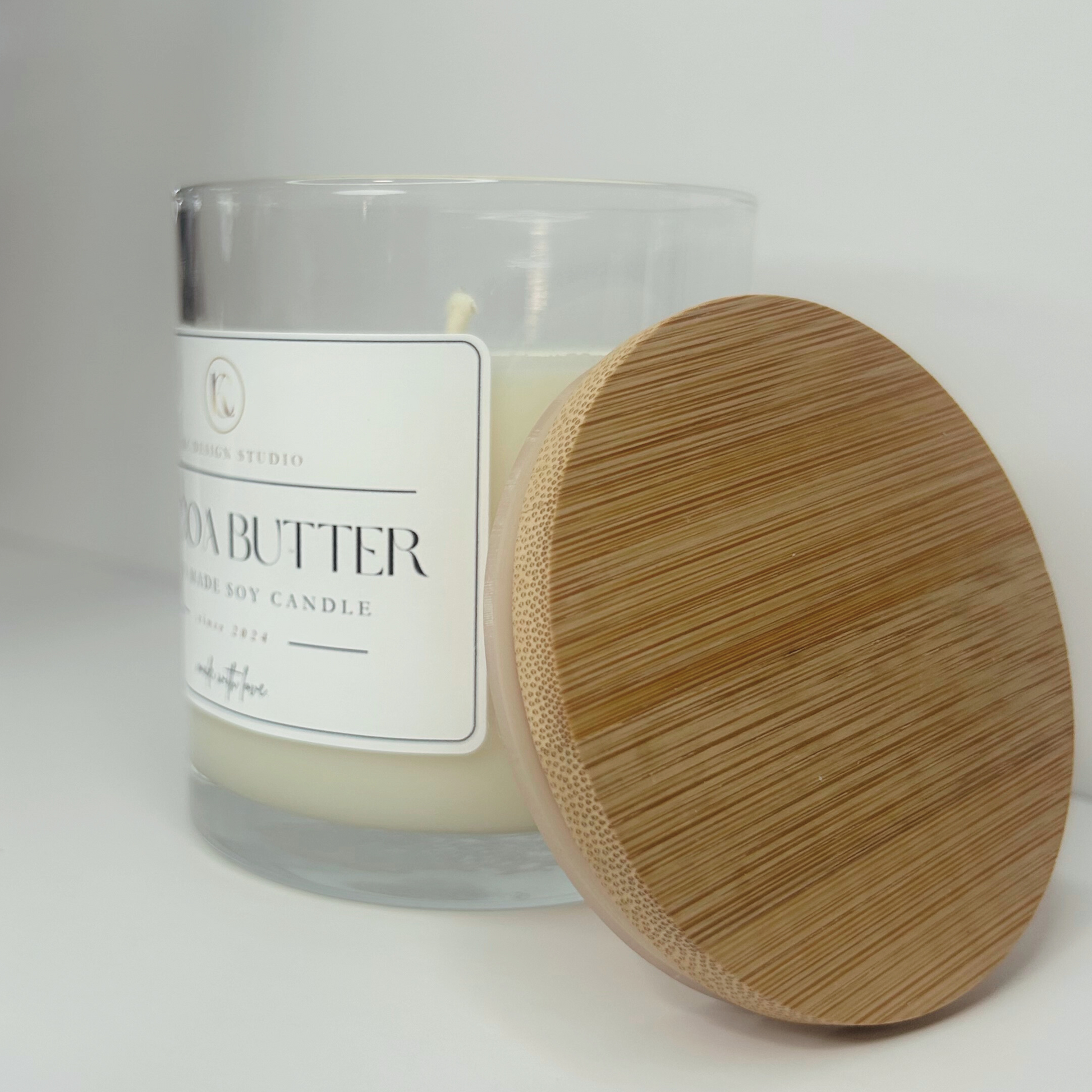 Left side view of the 10oz Cocoa Butter candle, showcasing its light, elegant design and premium craftsmanship.