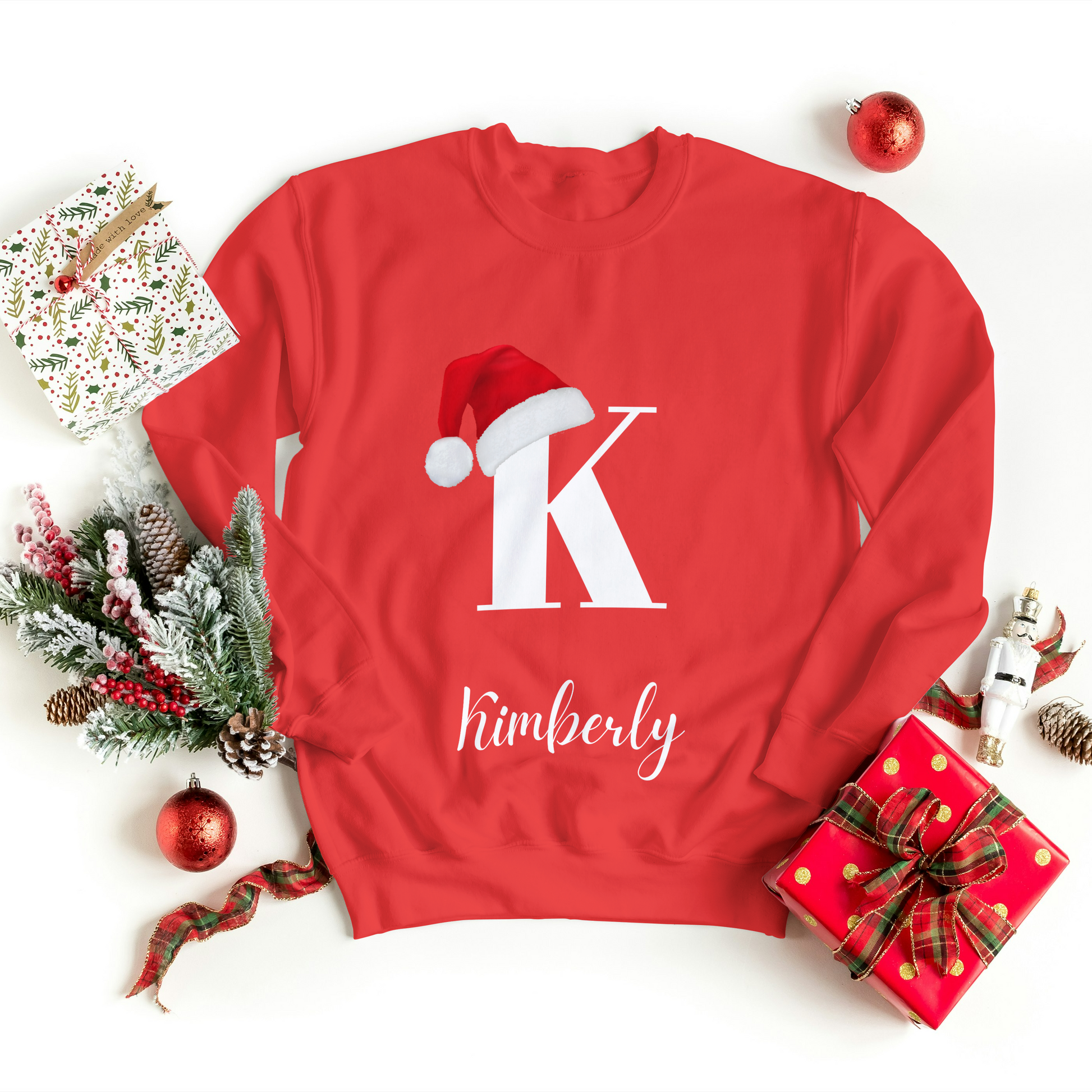 Custom Christmas sweatshirt in red with a Christmas hat on the initial and the option for a personalized name, perfect for the holiday season.