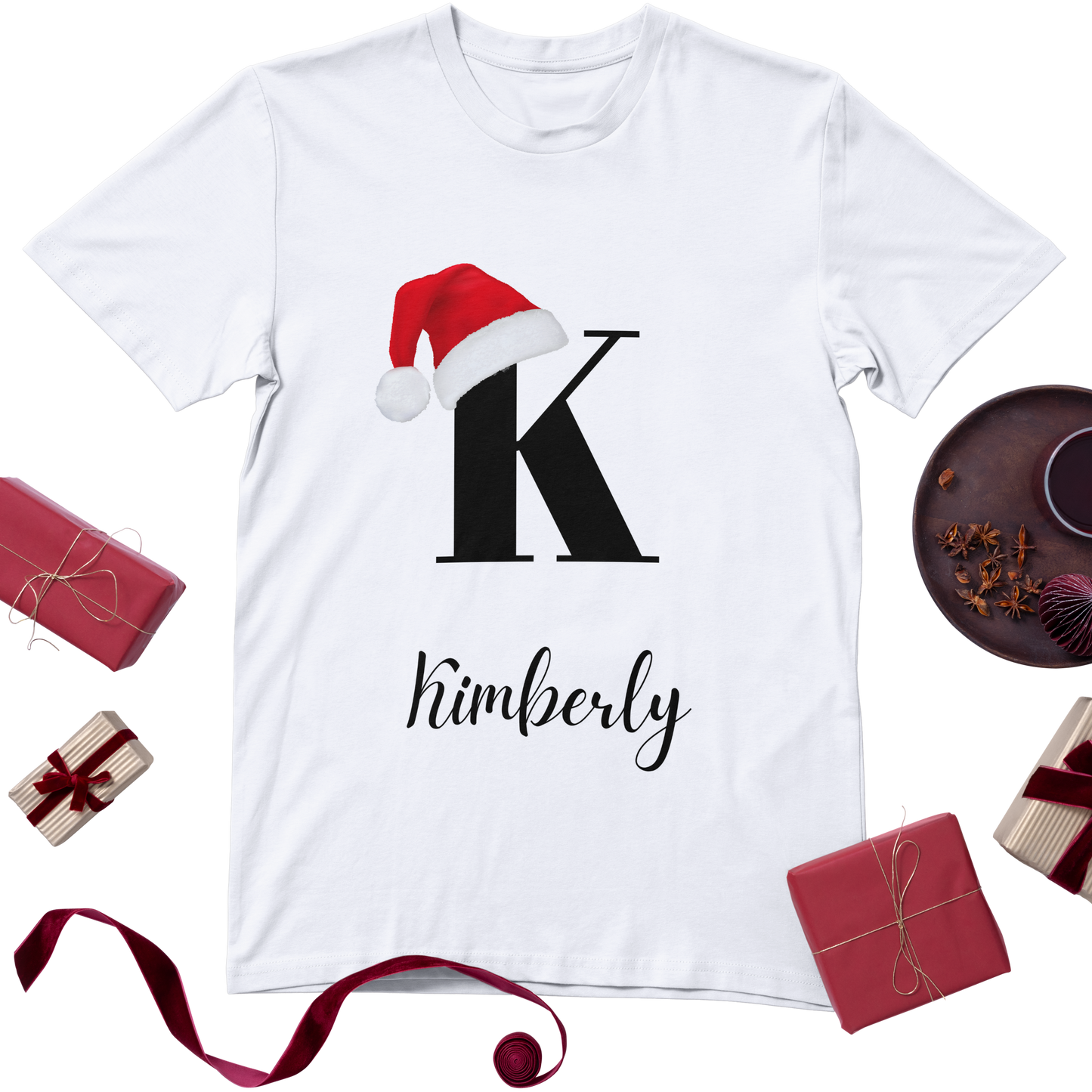 Custom Christmas t-shirt in white featuring a personalized initial with a Christmas hat and customizable name for a festive, personalized touch.