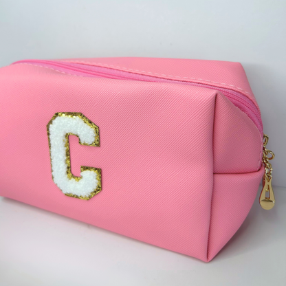 Personalized pink initial cosmetic pouch – angled view showcasing embroidery.