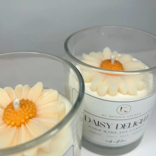 Close-up view of two 10oz Daisy Delight Candles, highlighting their all-natural soy wax and charming floral details.